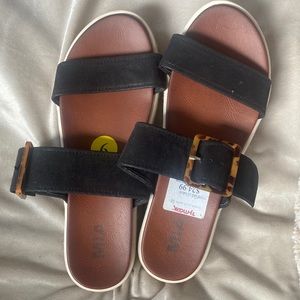 Platform sandals. Black strap with brown buckle. Never worn.